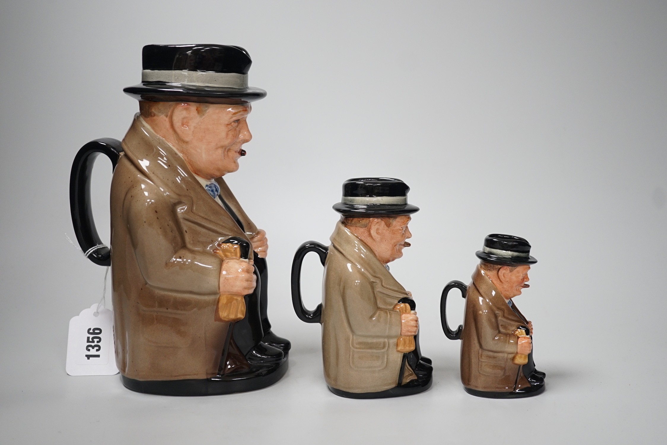 Three graduated Royal Doulton 'Churchill' character jugs, 23cm